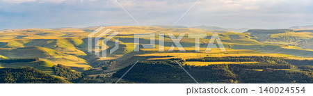 Layers of green mountains and hills in the haze during sunset. Panoramic View of Green hills and Meadow. Layers of green mountains and hills in the haze during sunset. Panoramic View of Green hills and Meadow. 140024554