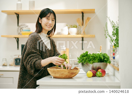 A woman cooking with fresh vegetables A woman cooking with fresh vegetables 140024618