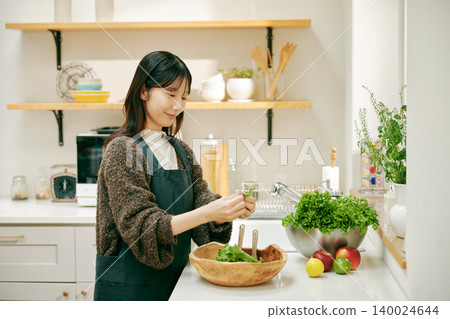 A woman cooking with fresh vegetables A woman cooking with fresh vegetables 140024644