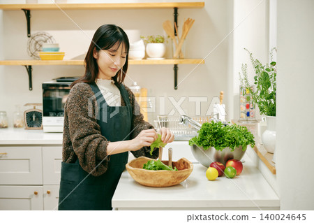 A woman cooking with fresh vegetables A woman cooking with fresh vegetables 140024645