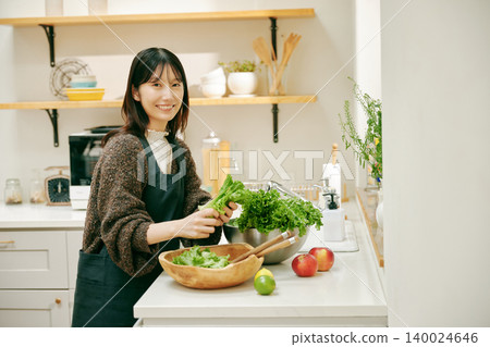 A woman cooking with fresh vegetables A woman cooking with fresh vegetables 140024646