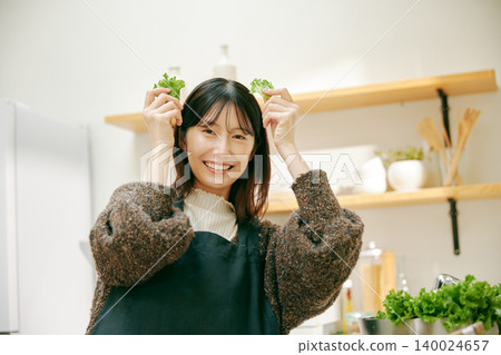 A woman cooking with fresh vegetables 140024657