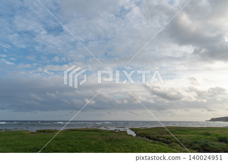 A grassland with a shallow, choppy coastline and an adjacent river that connects to the sea. A grassland with a shallow, choppy coastline and an adjacent river that connects to the sea. 140024951