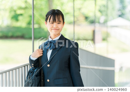 Middle school and high school girls in school uniforms in the school hallway. Middle school and high school girls in school uniforms in the school hallway. 140024960
