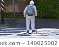 An elderly man with a cane (wearing a mask) crosses a pedestrian crossing in Yokohama, Japan. A dark shadow sways across the crosswalk... What is life...? 140025002