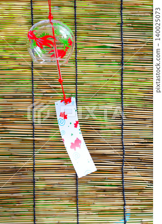 A garden with bamboo blinds and wind chimes that evoke the feeling of summer. A garden with bamboo blinds and wind chimes that evoke the feeling of summer. 140025073