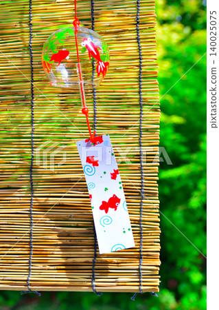 A garden with bamboo blinds and wind chimes that evoke the feeling of summer. A garden with bamboo blinds and wind chimes that evoke the feeling of summer. 140025075