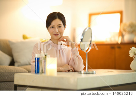 Middle-aged women doing their nighttime skincare routine 140025213