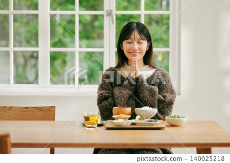 A woman eating a Japanese-style breakfast. A woman eating a Japanese-style breakfast. 140025218