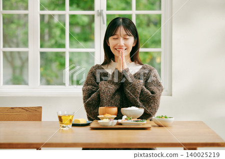 A woman eating a Japanese-style breakfast. A woman eating a Japanese-style breakfast. 140025219