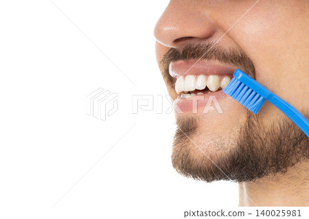 Man with a beard brushes teeth with a blue toothbrush, isolated, PNG 140025981