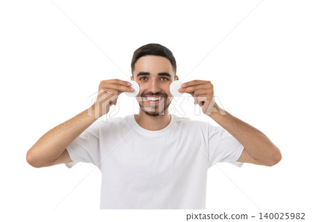 Man smiling while holding cotton pads on his face, isolated, PNG 140025982