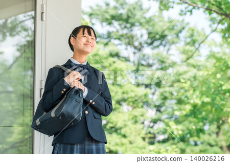 Middle school and high school girls in uniform walking down the school corridor. Middle school and high school girls in uniform walking down the school corridor. 140026216