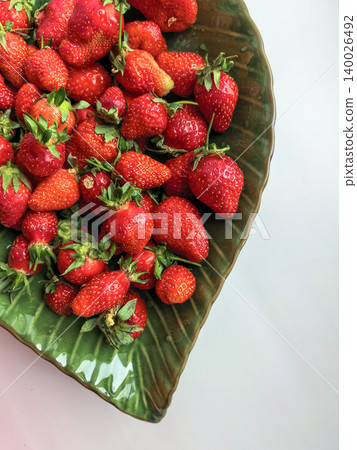 Ripe Strawberries On Large Green Leaf Surface 140026492