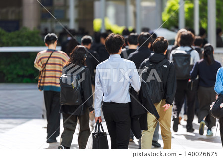 The back view of a young man leaving for work in the morning. 140026675