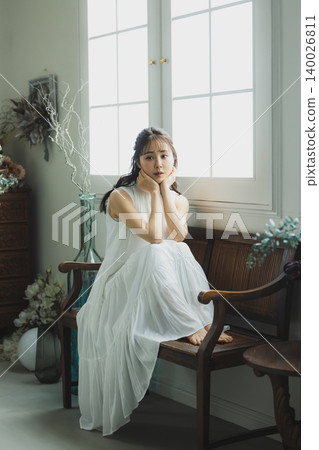 A young woman relaxing in a stylish room. A young woman relaxing in a stylish room. 140026811