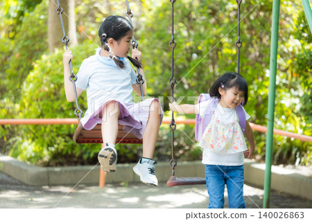 Girls playing in the park 140026863