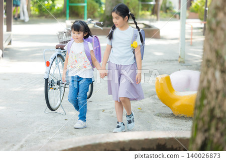 Girls playing in the park Girls playing in the park 140026873