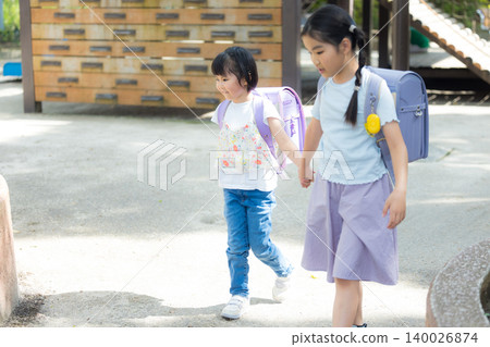 Girls playing in the park Girls playing in the park 140026874
