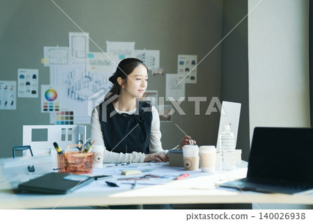 A woman working at a design firm 140026938