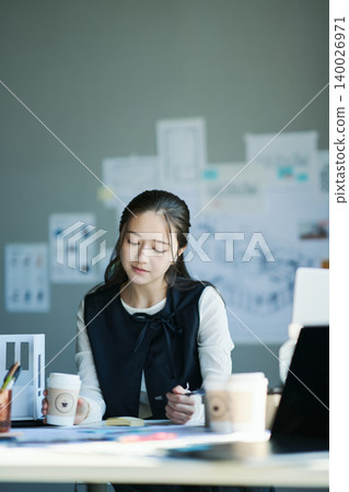 A woman working at a design firm A woman working at a design firm 140026971