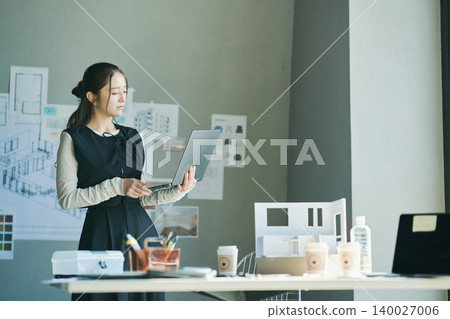 A woman working at a design firm A woman working at a design firm 140027006