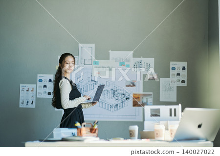 A woman working at a design firm A woman working at a design firm 140027022