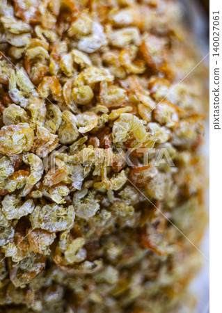 Dried Shrimps On Display At A Traditional Seafood Market. Close up of small dried shrimps for sale in local market, perfect for asian cuisine, ingredient and seafood industry themes. Dried Shrimps On Display At A Traditional Seafood Market. Close up of small dried shrimps for sale in local market, perfect for asian cuisine, ingredient and seafood industry themes. 140027061