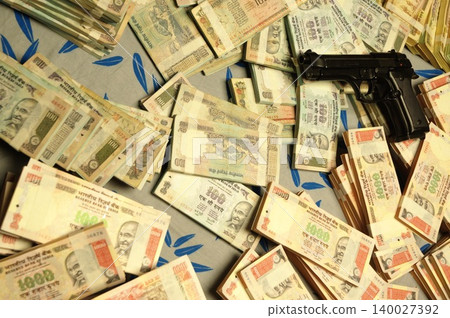 Indian Currency Gun on Bed Indian Currency Gun on Bed 140027392