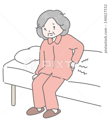 An elderly woman suffering from lower back pain upon waking up in bed. 140027552