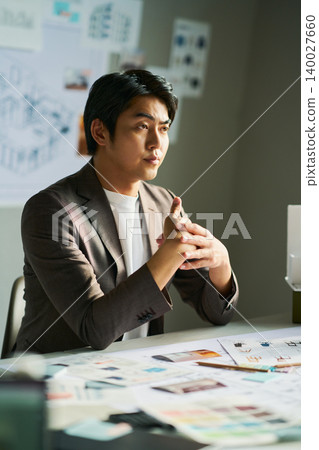 A male chief designer brainstorming ideas. 140027660