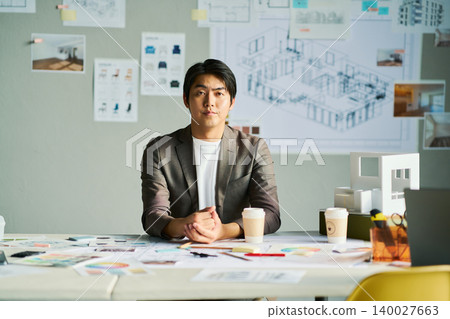 A male chief designer brainstorming ideas. A male chief designer brainstorming ideas. 140027663