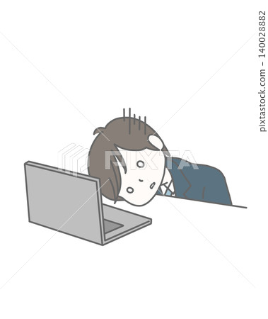 A man in a suit, looking despairing and depressed in front of his computer. 140028882
