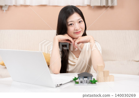Young women considering home loans and investments 140030269