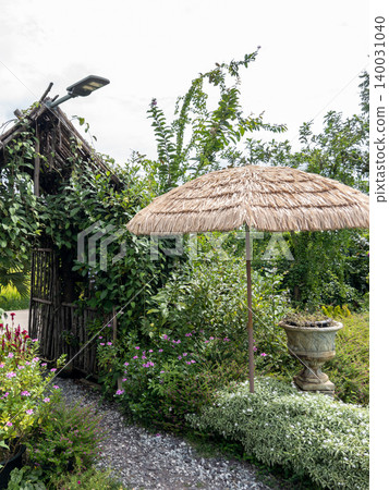 Rustic Tropical Garden With Thatched Umbrella And Wooden Arch 140031040