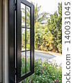 Modern Black Frame Window Open to Tropical Garden 140031045