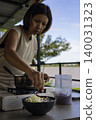 Woman Garnishing Kanom Jeen Nam Ngiew In A Bowl, chef preparing authentic thai noodle soup for restaurant menu marketing campaign, brand awareness, traditional asian culinary food and lifestyle. 140031323