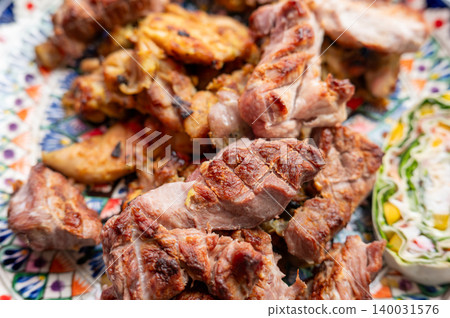 Closeup grilled lamb and chicken served on decorative plate 140031576