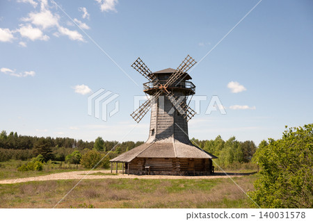Rustic wooden windmill in countryside landscape with clear blue sky Rustic wooden windmill in countryside landscape with clear blue sky 140031578
