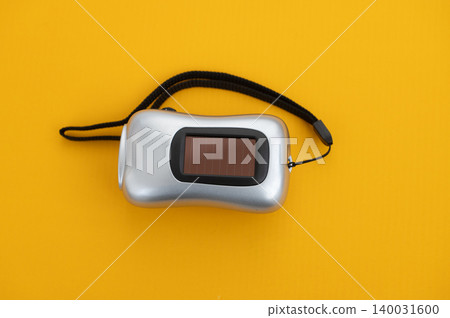 Portable solar-powered flashlight on bright yellow background Portable solar-powered flashlight on bright yellow background 140031600