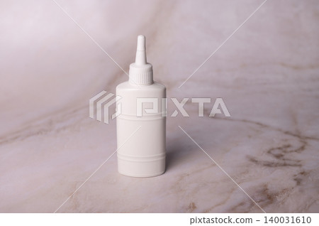 White plastic dropper bottle on marble surface White plastic dropper bottle on marble surface 140031610