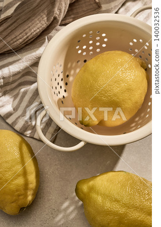 Fresh Lemons in a Vintage Colander with Sunny Shadows. Top View Fresh Lemons in a Vintage Colander with Sunny Shadows. Top View 140032536