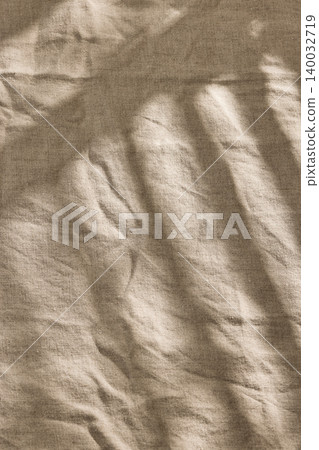 Sunny Blinds Shadow Pattern on a Textured Linen Tablecloth in Warm Tones Sunny Blinds Shadow Pattern on a Textured Linen Tablecloth in Warm Tones 140032719