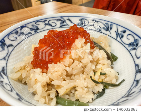 Rice cooked with wild vegetables. A dish of seasoned rice cooked together with wild vegetables. Served with salmon roe. 140032865