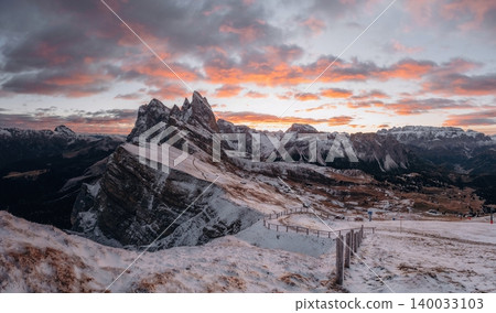 Panoramic view of Seceda in the Dolomites covered with first snow, dramatic sky and soft golden hour sunlight. Majestic alpine peaks, winter mountain landscape Panoramic view of Seceda in the Dolomites covered with first snow, dramatic sky and soft golden hour sunlight. Majestic alpine peaks, winter mountain landscape 140033103