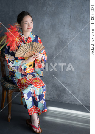 A Japanese-style beauty portrait of a Japanese woman in a yukata surrounded by spider lilies. A Japanese-style beauty portrait of a Japanese woman in a yukata surrounded by spider lilies. 140033321