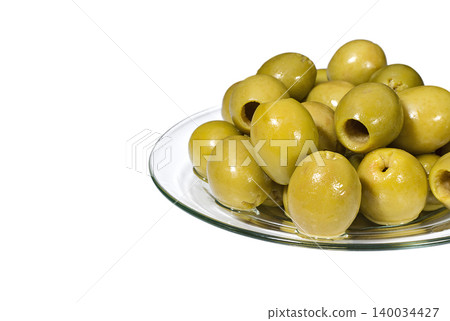 Green pitted olives on a glass plate 140034427
