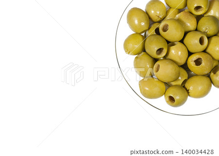 Green pitted olives on a transparent glass plate 140034428