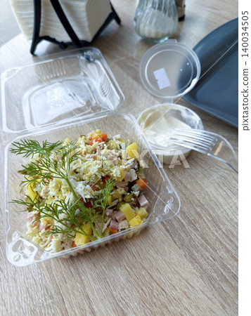 Salad in a disposable plastic container. 140034505