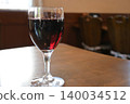 Red wine poured into a glass 140034512